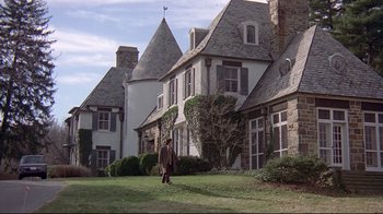 Movie still from “And Justice for All” (1979), directed by Norman Jewison – A man walking in front of a large white house; Extreme Wide shot, Low angle