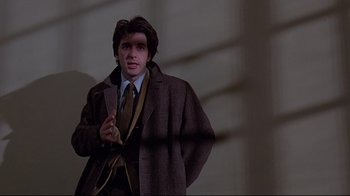 Movie still from “And Justice for All” (1979), directed by Norman Jewison – A man wearing a suit and tie holding a banana; Medium shot, Low angle