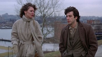 Movie still from “And Justice for All” (1979), directed by Norman Jewison – A man and a woman standing next to each other outside; Medium shot, Low angle