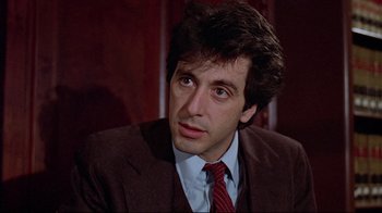 Movie still from “And Justice for All” (1979), directed by Norman Jewison – A person wearing a suit and tie; Close Up shot, Over the shoulder angle