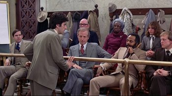 Movie still from “And Justice for All” (1979), directed by Norman Jewison – A group of men sitting around a bench; Wide shot, Over the shoulder angle