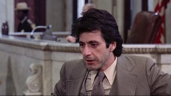 Movie still from “And Justice for All” (1979), directed by Norman Jewison – A person wearing a suit and tie; Close Up shot, Over the shoulder angle