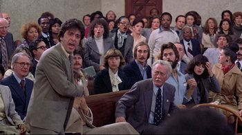 Movie still from “And Justice for All” (1979), directed by Norman Jewison – A group of people sitting in front of each other in a room; Medium shot, High angle