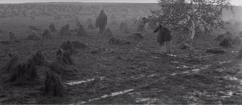 Movie still from “Andrei Rublev” (1966), directed by Andrei Tarkovsky – A black and white photo of a person in a field; Extreme Wide shot, High angle