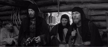 Movie still from “Andrei Rublev” (1966), directed by Andrei Tarkovsky – A group of men standing next to each other; Medium shot, Low angle