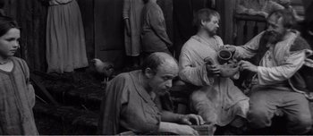 Movie still from “Andrei Rublev” (1966), directed by Andrei Tarkovsky – A group of people standing around a building; Medium shot, High angle