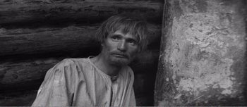 Movie still from “Andrei Rublev” (1966), directed by Andrei Tarkovsky – Black and white photograph of a man with a beard; Close Up shot, High angle