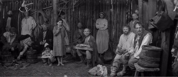 Movie still from “Andrei Rublev” (1966), directed by Andrei Tarkovsky – A black and white photo of a group of men and women; Wide shot, High angle