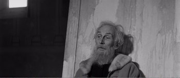 Movie still from “Andrei Rublev” (1966), directed by Andrei Tarkovsky – An old man with a long white beard; Close Up shot, Low angle