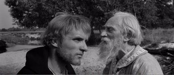 Movie still from “Andrei Rublev” (1966), directed by Andrei Tarkovsky – A man and an old man standing next to each other; Close Up shot, Over the shoulder angle