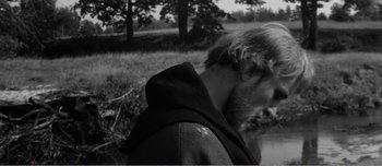 Movie still from “Andrei Rublev” (1966), directed by Andrei Tarkovsky – Black and white photograph of a man with a beard; Close Up shot, Over the shoulder angle