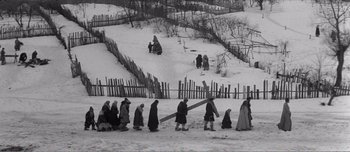 Movie still from “Andrei Rublev” (1966), directed by Andrei Tarkovsky – A black and white photo of people walking in the snow; Extreme Wide shot, High angle