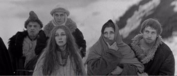 Movie still from “Andrei Rublev” (1966), directed by Andrei Tarkovsky – A group of people standing next to each other in the snow; Medium shot, High angle