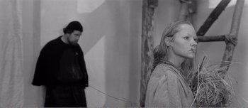 A man and a woman are standing in a room