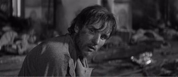 Movie still from “Andrei Rublev” (1966), directed by Andrei Tarkovsky – Black and white photograph of a man with wet hair; Close Up shot, Over the shoulder angle