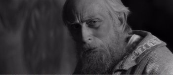 Movie still from “Andrei Rublev” (1966), directed by Andrei Tarkovsky – An old man with a long white beard; Close Up shot, Over the shoulder angle