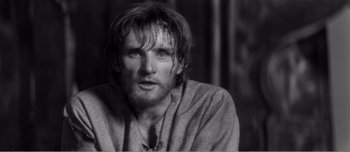 Movie still from “Andrei Rublev” (1966), directed by Andrei Tarkovsky – Black and white photograph of a man with wet hair; Close Up shot, Over the shoulder angle