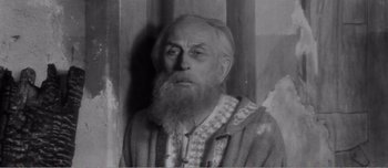 Movie still from “Andrei Rublev” (1966), directed by Andrei Tarkovsky – An old man with a long white beard; Close Up shot, Low angle