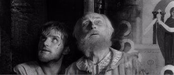 Movie still from “Andrei Rublev” (1966), directed by Andrei Tarkovsky – A man with a beard and a man with a beard and a man with a beard; Close Up shot, Low angle