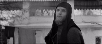 Movie still from “Andrei Rublev” (1966), directed by Andrei Tarkovsky – A man with a long beard wearing a black robe; Close Up shot, Low angle
