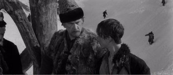 Movie still from “Andrei Rublev” (1966), directed by Andrei Tarkovsky – A man and a boy are talking to each other; Medium shot, Over the shoulder angle