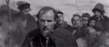 Movie still from “Andrei Rublev” (1966), directed by Andrei Tarkovsky – Black and white photograph of a man with a beard; Close Up shot, Low angle