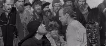 Movie still from “Andrei Rublev” (1966), directed by Andrei Tarkovsky – A group of men standing next to each other; Medium shot, Over the shoulder angle