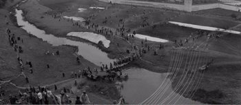 Movie still from “Andrei Rublev” (1966), directed by Andrei Tarkovsky – An aerial view of people walking across a bridge; Extreme Wide shot, High angle