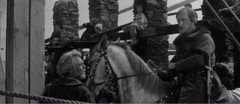 Movie still from “Andrei Rublev” (1966), directed by Andrei Tarkovsky – A group of people riding on the back of a horse; Medium shot, Low angle