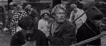 Movie still from “Andrei Rublev” (1966), directed by Andrei Tarkovsky – An old photo of a man with a long beard; Medium shot, High angle