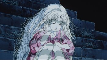 Movie still from “Angel's Egg” (1985), directed by Mamoru Oshii – An animated scene of a girl with long white hair sitting on steps; Close Up shot, High angle