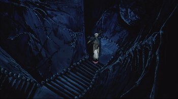 Movie still from “Angel's Egg” (1985), directed by Mamoru Oshii – An animated scene of a man holding a telescope and walking down a staircase; Wide shot, High angle