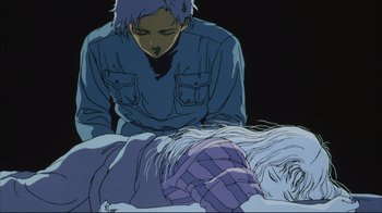Movie still from “Angel's Egg” (1985), directed by Mamoru Oshii – An animated scene of a man looking at a sleeping woman; Medium shot, Low angle