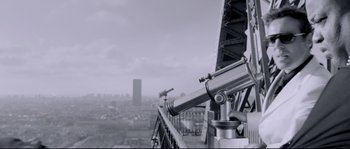 Movie still from “Angel-A” (2005), directed by Luc Besson – A telescope on the side of a building; Extreme Wide shot, Low angle