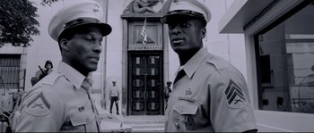 Movie still from “Angel-A” (2005), directed by Luc Besson – A black and white photo of two men in military uniforms; Medium shot, Low angle