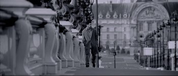 Movie still from “Angel-A” (2005), directed by Luc Besson – A black and white photo of a man in a suit; Wide shot, Low angle