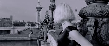 Movie still from “Angel-A” (2005), directed by Luc Besson – A black and white photo of a woman in a black dress; Medium shot, Over the shoulder angle