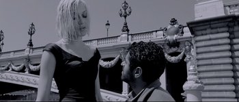 Movie still from “Angel-A” (2005), directed by Luc Besson – A man and a woman in front of an ornate building; Medium shot, Low angle