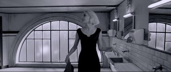 Movie still from “Angel-A” (2005), directed by Luc Besson – A woman in a black dress in front of a kitchen window; Medium shot, Low angle