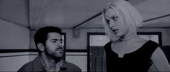 Movie still from “Angel-A” (2005), directed by Luc Besson – A man and a woman are talking in a room; Medium shot, Over the shoulder angle