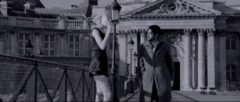 Movie still from “Angel-A” (2005), directed by Luc Besson – A man and a woman standing next to a street light; Medium shot, Low angle
