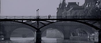 Movie still from “Angel-A” (2005), directed by Luc Besson – Two people standing on a bridge over a body of water; Extreme Wide shot, Low angle