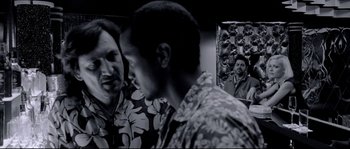 Movie still from “Angel-A” (2005), directed by Luc Besson – Two men talking in front of a painting; Medium shot, Over the shoulder angle