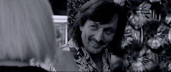 Movie still from “Angel-A” (2005), directed by Luc Besson – A person smiling for the camera; Close Up shot, Over the shoulder angle