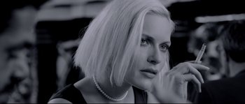 Movie still from “Angel-A” (2005), directed by Luc Besson – A black and white photo of a woman with white hair; Close Up shot, Over the shoulder angle