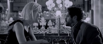 Movie still from “Angel-A” (2005), directed by Luc Besson – A man and a woman talking to each other in front of a chandelier; Medium shot, Over the shoulder angle