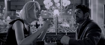 Movie still from “Angel-A” (2005), directed by Luc Besson – A woman sitting at a table in front of a man; Medium shot, Over the shoulder angle