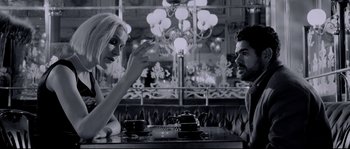 Movie still from “Angel-A” (2005), directed by Luc Besson – A man and a woman sitting at a table in front of a tea pot; Medium shot, Over the shoulder angle