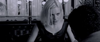 Movie still from “Angel-A” (2005), directed by Luc Besson – A black and white photo of a woman with blonde hair; Close Up shot, Over the shoulder angle