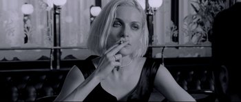 Movie still from “Angel-A” (2005), directed by Luc Besson – A woman smoking a cigarette while wearing a necklace; Close Up shot, Low angle